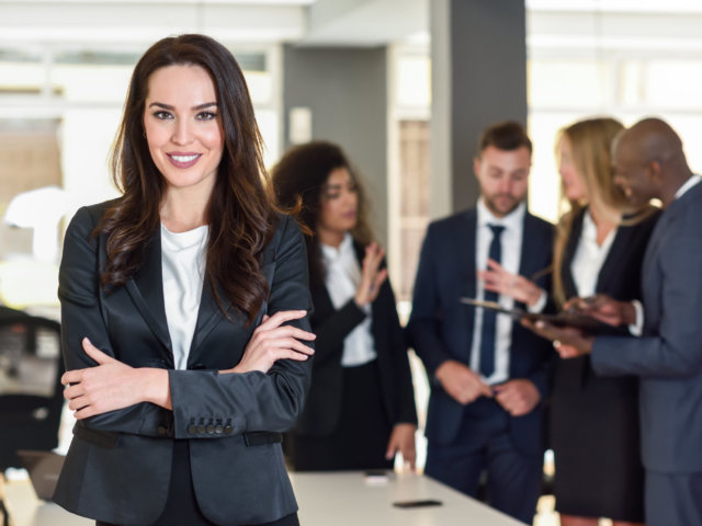 Businesswoman leader in modern office with businesspeople workin