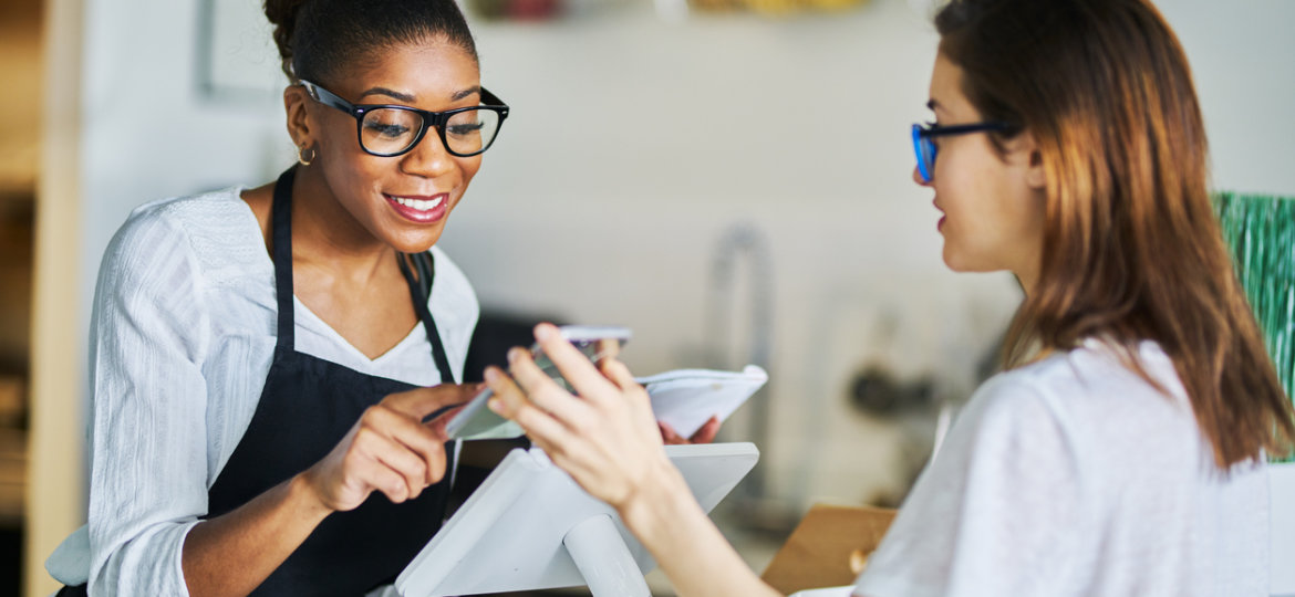 customer using online coupon from smartphone app at restaurant